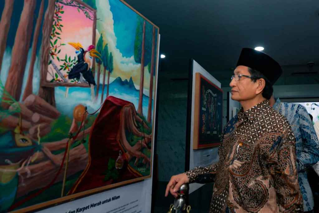 A visitor looking at artwork at The Future Is Our Canvas exhibition